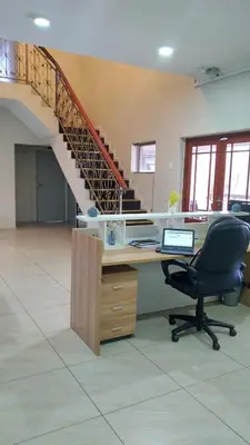 an office with a desk with a chair and a staircase at Palm View Midrand Guest House in Midrand