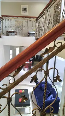 a staircase in a house with a blue chair at Palm View Midrand Guest House in Midrand