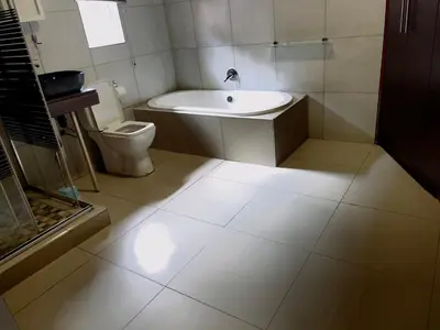 a bathroom with a sink and a toilet at Galaxy Guest House Pretoria in Pretoria