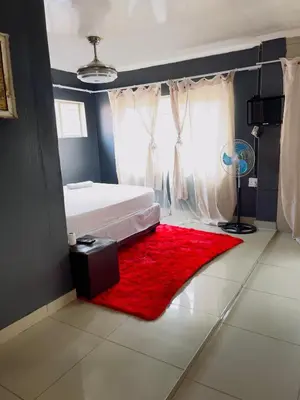 a bedroom with a bed and a red rug at Galaxy Guest House Pretoria in Pretoria