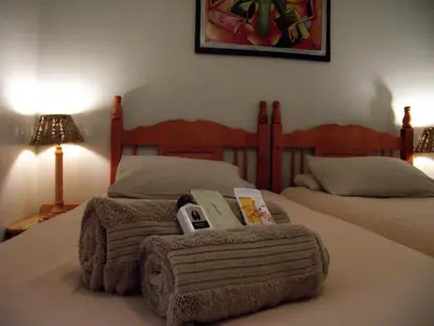 a bed with a blanket and a book on it at Jock-Sabie Lodge in Sabie