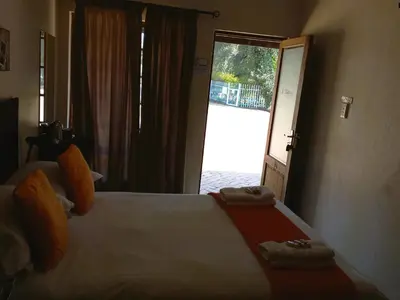 a bedroom with a large bed with towels on it at OR Tambo Guest House in Kempton Park