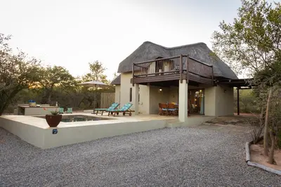 a house with a deck and a patio with a pool at Larima Bush Retreat in Hoedspruit