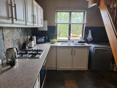 a kitchen with a sink and a stove top oven at Larima Bush Retreat in Hoedspruit