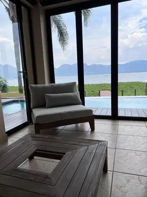 a living room with a couch and a large window at Pecanwood Dam View in Hartbeespoort