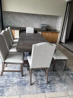 a dining room table and chairs in a room at Pecanwood Dam View in Hartbeespoort