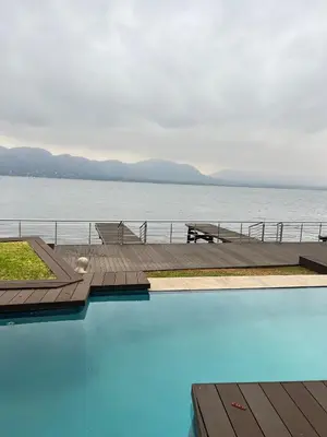 a large swimming pool next to a body of water at Pecanwood Dam View in Hartbeespoort