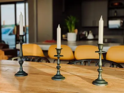 two candlesticks on a table with two candles on it at The Big Easy Rest at Highland Gate Golf & Trout in Dullstroom