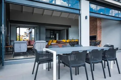 a dining table and chairs on a patio at The Big Easy Rest at Highland Gate Golf & Trout in Dullstroom
