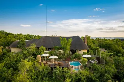 an aerial view of a house with a thatched roof at Bushwa Private Game Lodge in Vaalwater