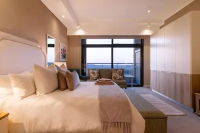 a bedroom with a large bed with a large window at Alimama Spaces: Koketso's Menlyn Maine in Pretoria