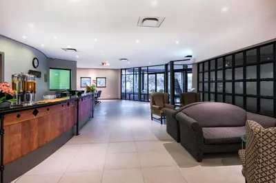 a lobby of a hospital with chairs and a bar at aha Kopanong Hotel & Conference Centre in Bredell