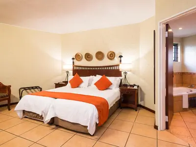 a hotel room with a bed and a bath tub at aha Kopanong Hotel & Conference Centre in Bredell