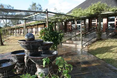 a garden with a fountain in the middle of a building at Destiny Lodge in White River
