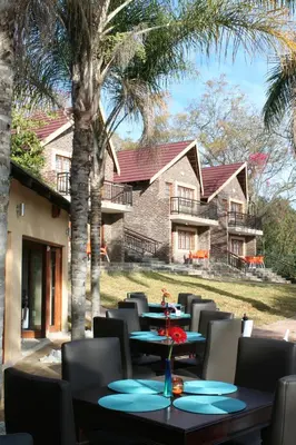 a group of tables and chairs in front of a house at Destiny Lodge in White River