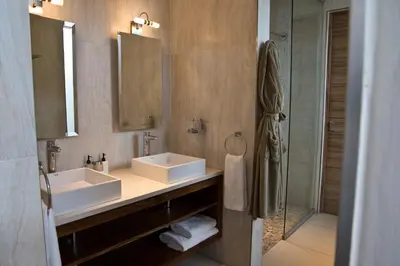 a bathroom with two sinks and a shower at Menlyn Boutique Hotel in Pretoria