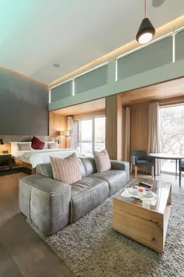 a living room with a couch and a bed at Menlyn Boutique Hotel in Pretoria