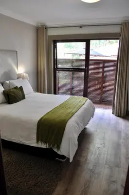 a bedroom with a large bed and a large window at Menlyn Boutique Hotel in Pretoria