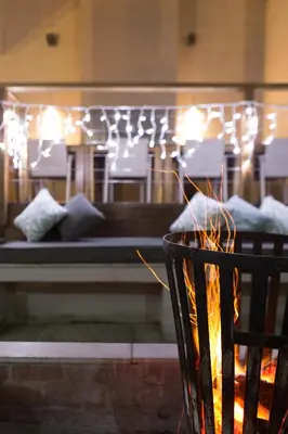 a fire pit with a bed in the background at Menlyn Boutique Hotel in Pretoria