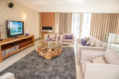 a living room with a couch and a coffee table at Menlyn Boutique Hotel in Pretoria