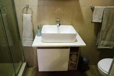 a bathroom with a white sink and a toilet at Serene Luxury retreat in Cullinan in Cullinan