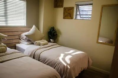 two beds sitting next to each other in a room at Serene Luxury retreat in Cullinan in Cullinan
