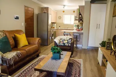 a living room with a couch and a table at Serene Luxury retreat in Cullinan in Cullinan