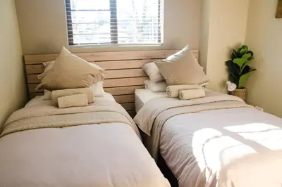two beds sitting next to each other in a room at Serene Luxury retreat in Cullinan in Cullinan