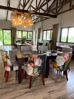 a dining room with a table and chairs at Nut Grove Boutique Hotel in White River