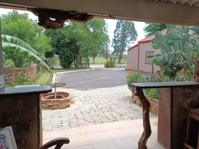 a view of a patio with a table and a driveway at KHAYA LANGA Guest House & Contractors Accommodation in Machadodorp