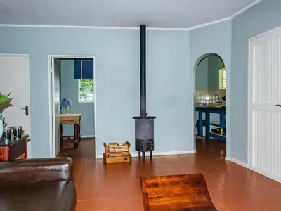 a living room with a wood stove in it at Wellstead Country Manor in Haenertsburg
