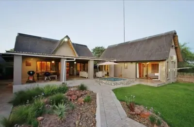 a large house with a patio and a yard at Buhala @ 411 in Hoedspruit