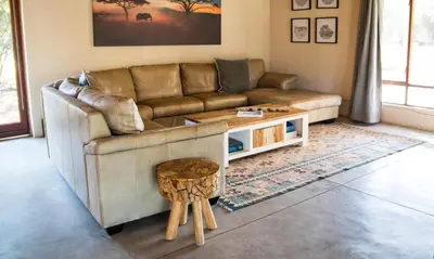 a living room with a couch and a table at Buhala @ 411 in Hoedspruit