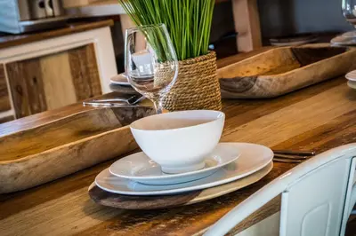 a table with a cup of coffee and a wine glass at Buhala @ 411 in Hoedspruit