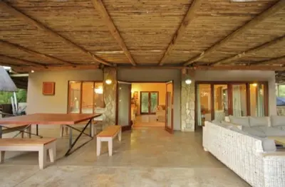 a living room with a couch and a table at Buhala @ 411 in Hoedspruit