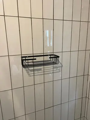 a white tiled wall with a glass shelf on it at TWO Prefab Living - Luxury bungalows in Dullstroom