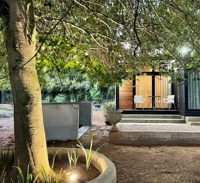 a house with a tree in front of it at TWO Prefab Living - Luxury bungalows in Dullstroom