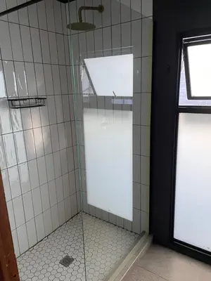 a bathroom with a shower with a glass door at TWO Prefab Living - Luxury bungalows in Dullstroom