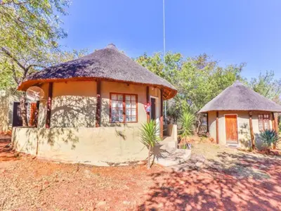 a small house with a thatched roof at Thuto Centre Conferencing & Bush Lodge in Bela-Bela