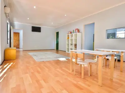 a living room with a table and chairs at Thuto Centre Conferencing & Bush Lodge in Bela-Bela