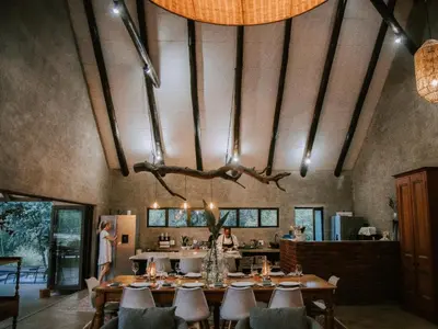 a dining room with a long table and chairs at Rhino's Rest Private Luxury Villa in Hoedspruit