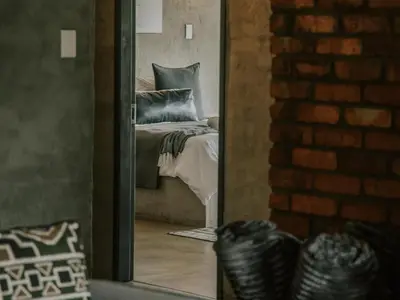 a mirror reflection of a bed in a bedroom at Rhino's Rest Private Luxury Villa in Hoedspruit