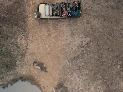 a group of people standing around a car in the dirt at Rhino's Rest Private Luxury Villa in Hoedspruit