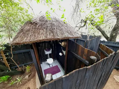 a small dog house with a toilet in it at Off Beat Safaris Bush Lodge in Hoedspruit