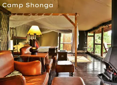 a living room with a couch and a tent at Shishangeni Lodge In Kruger National Park in Komatipoort