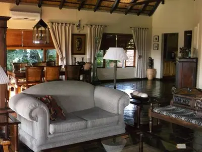 a living room with a couch and a table at Khandizwe Kruger Villa in Malelane