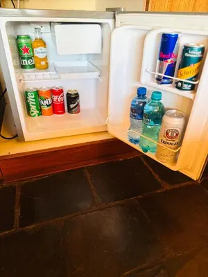 an open refrigerator filled with lots of drinks and water at Khandizwe Kruger Villa in Malelane