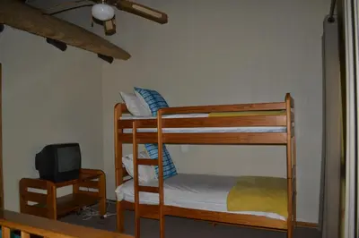 a bedroom with two bunk beds and a tv at Kruger Park Lodge - Golf Safari SA in Hazyview