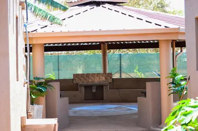 an outdoor pavilion with a bench under it at Makobaneng Guesthouse in Ga-Raphokola