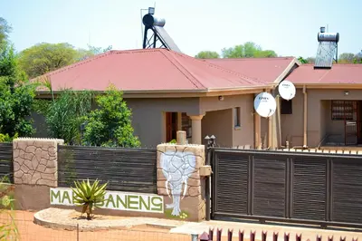 a house with a fence in front of it at Makobaneng Guesthouse in Ga-Raphokola